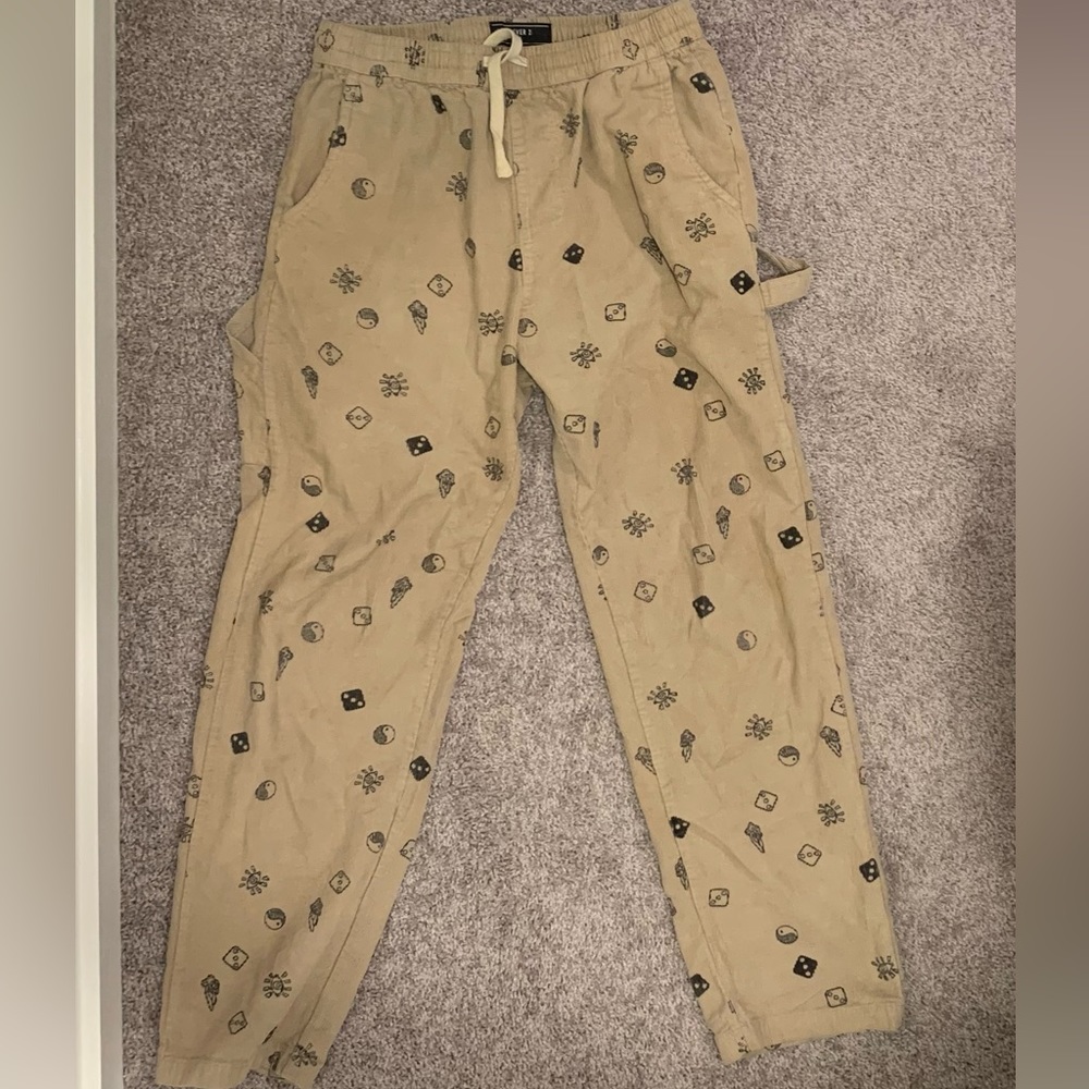 Forever 21 beige corduroy pants with mushroom, yin yang, and dice prints on it.